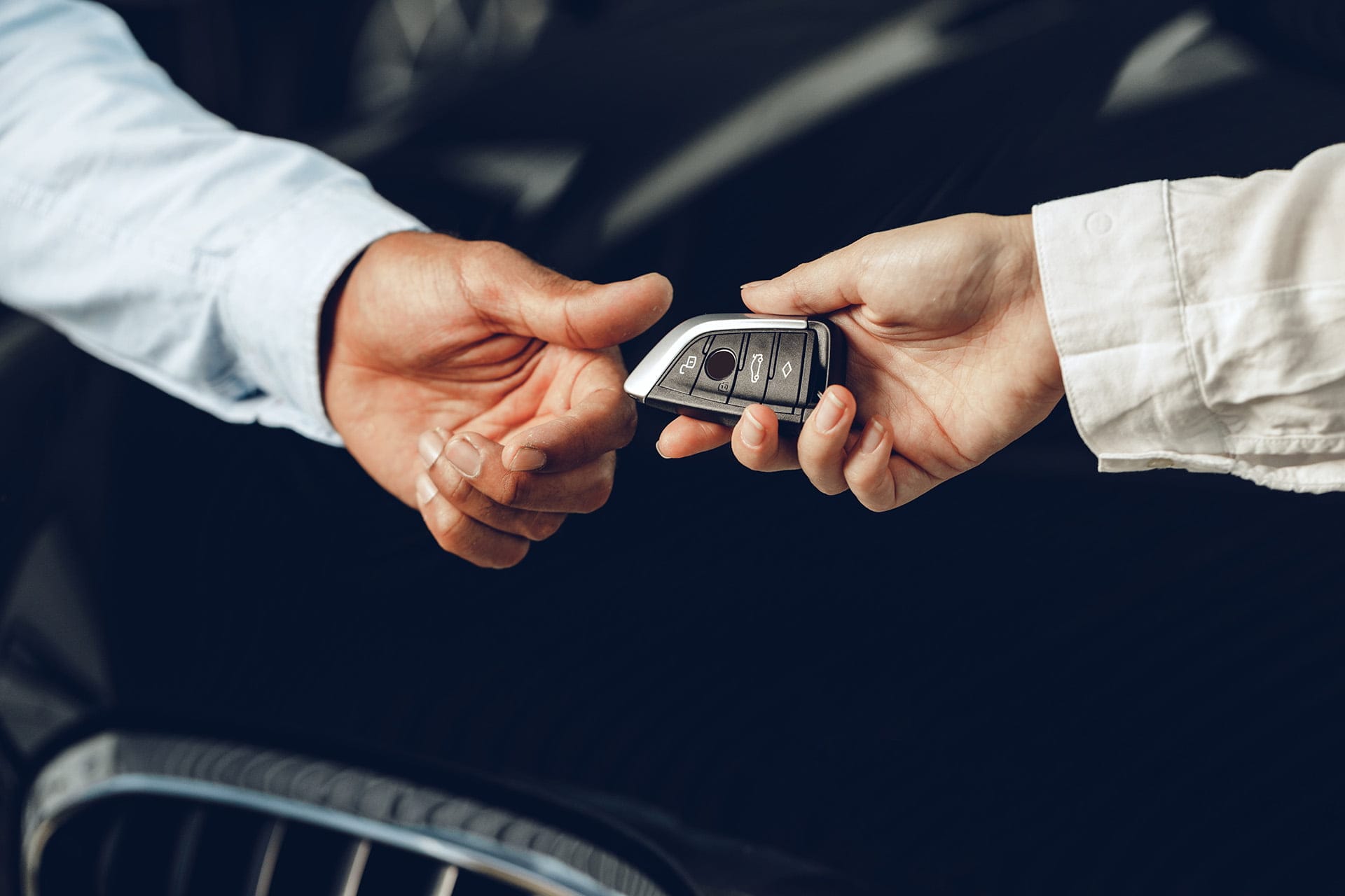 car salesperson giving keys to a client close up 2023 11 27 05 05 00 utc